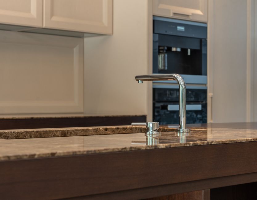Stainless steel kitchen faucet installed at a sink